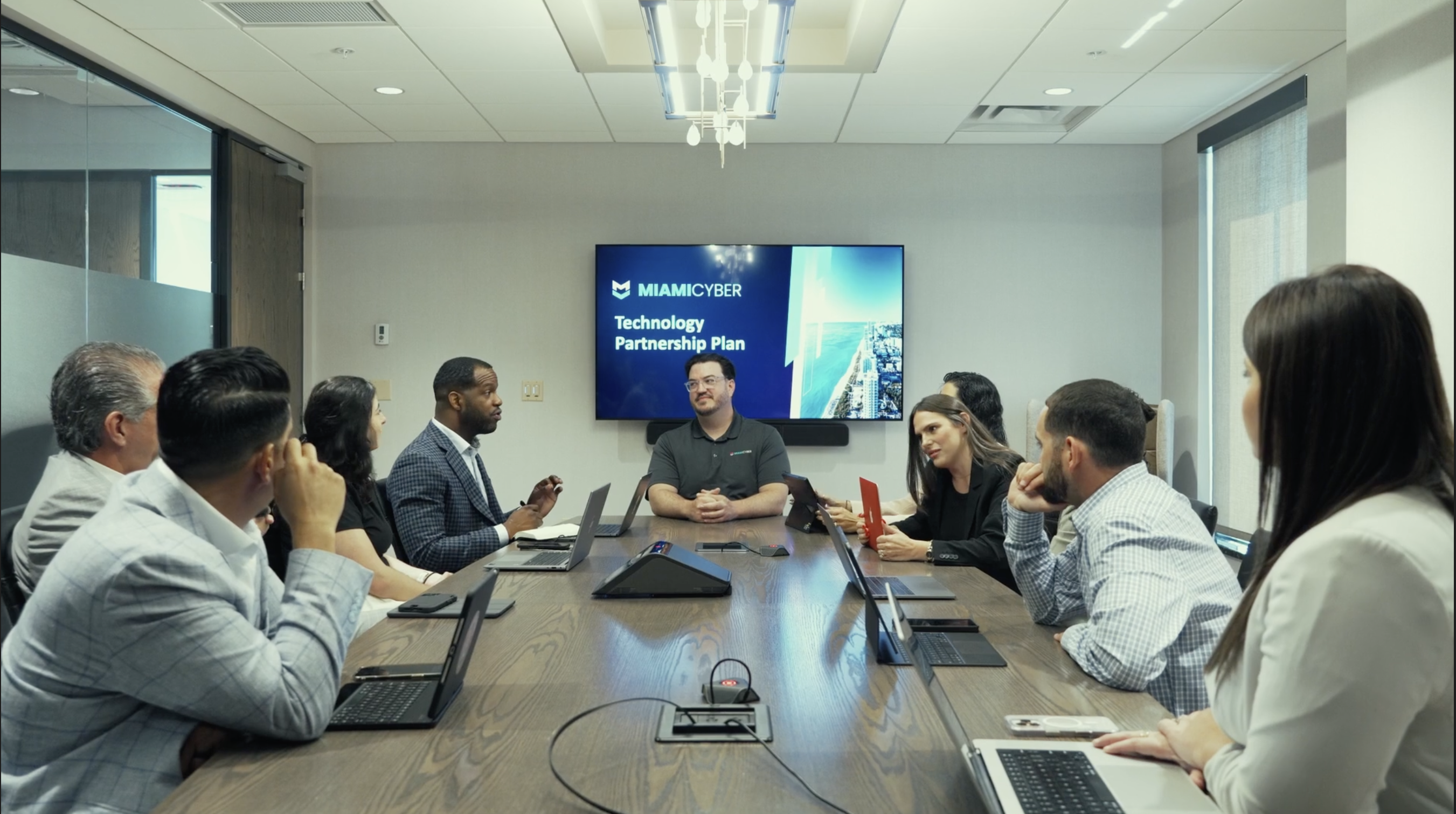 Miami Cyber team in a modern conference room